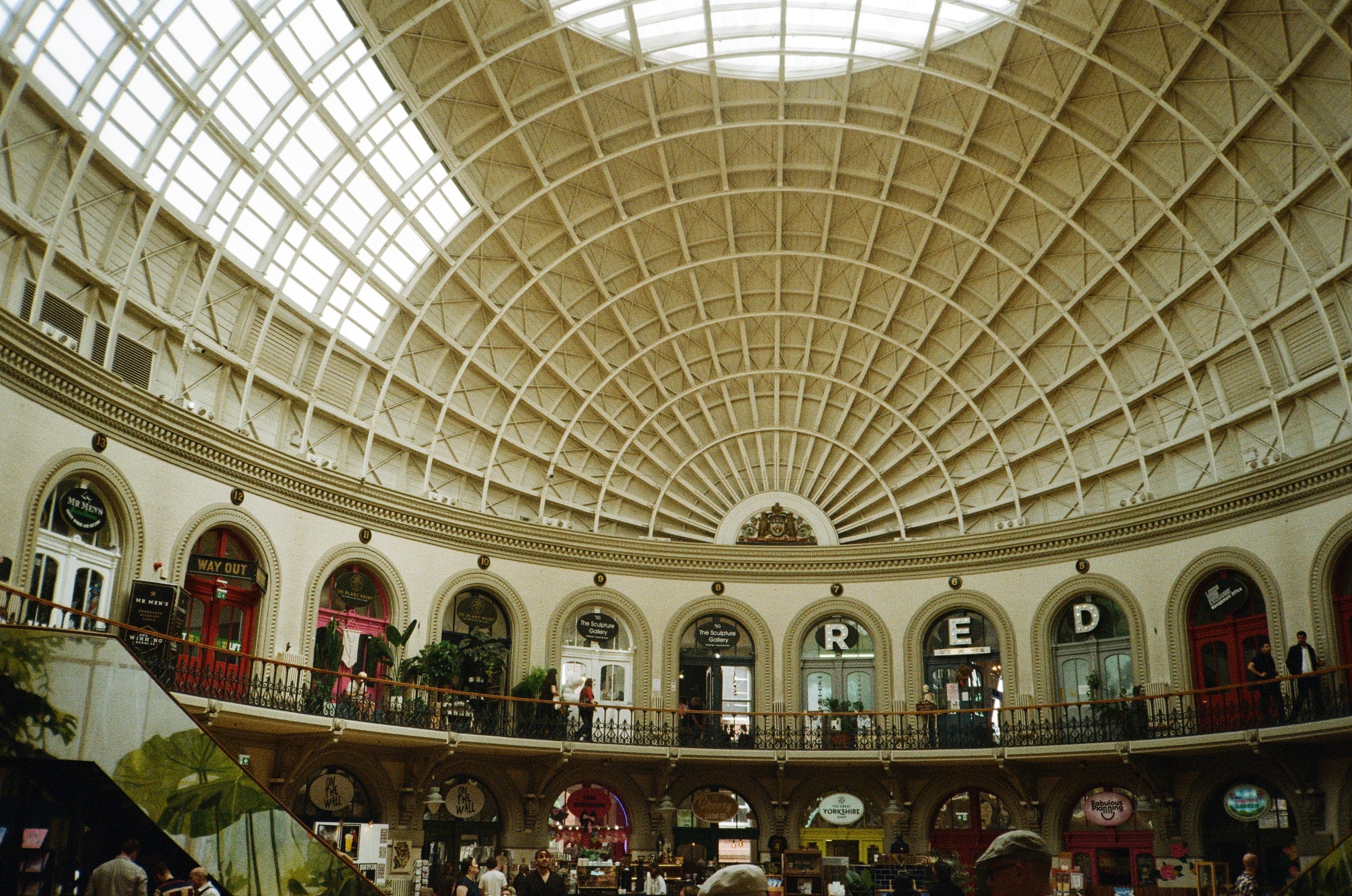 A domed, glass-roofed hall seen from its upper gallery