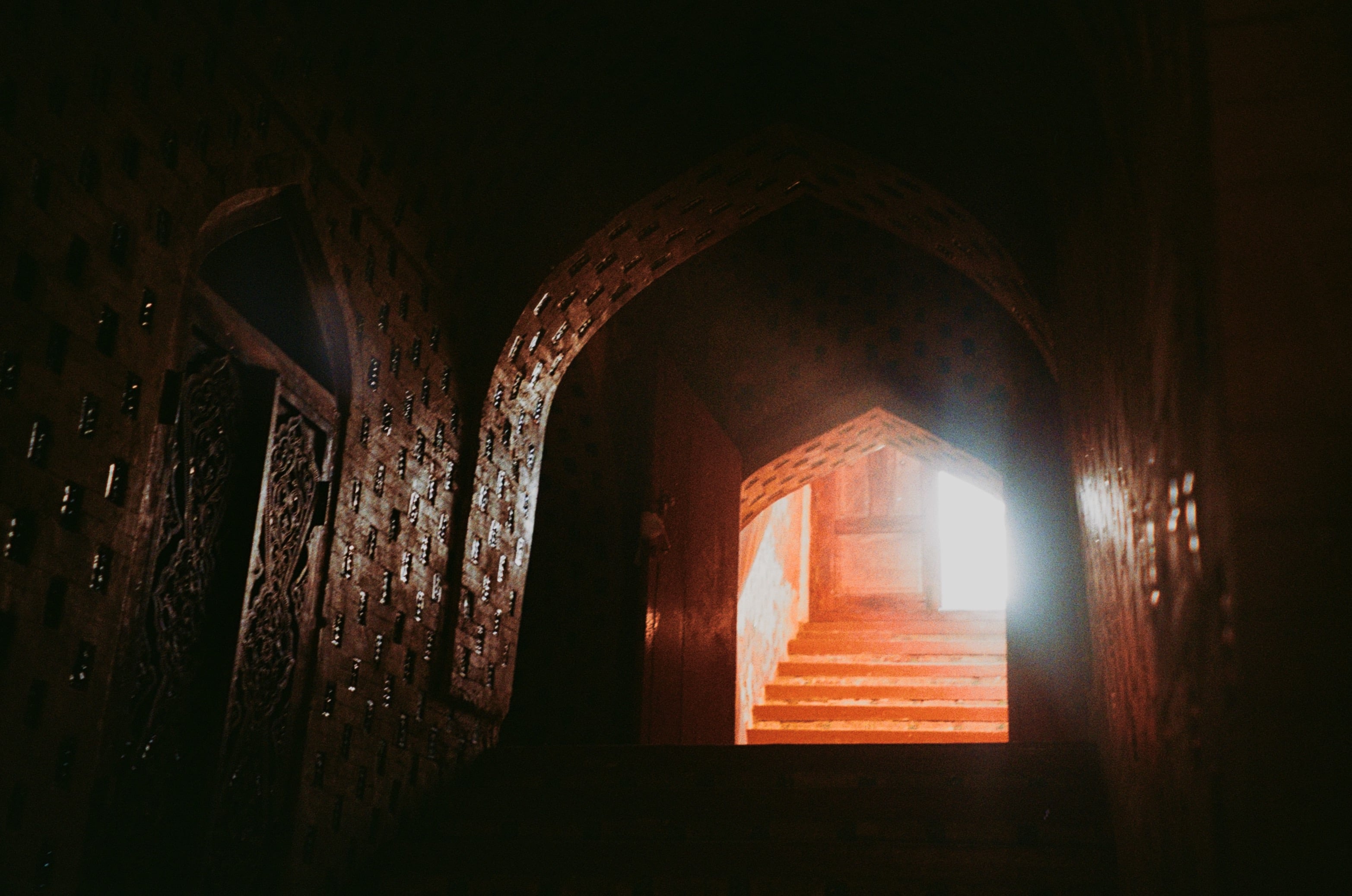 Light falling on steps at the end of a dark passage