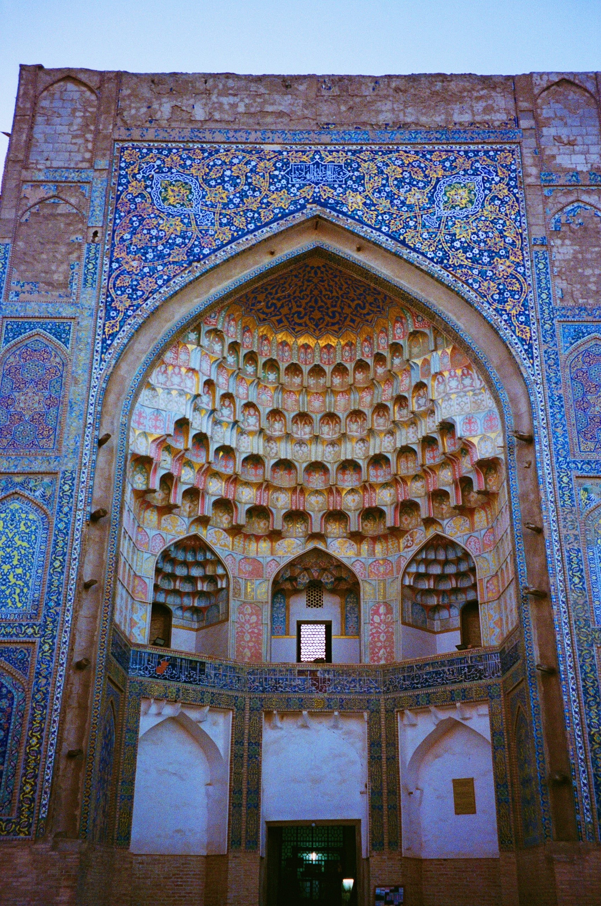 Looking up into a tiled, honeycombed arch