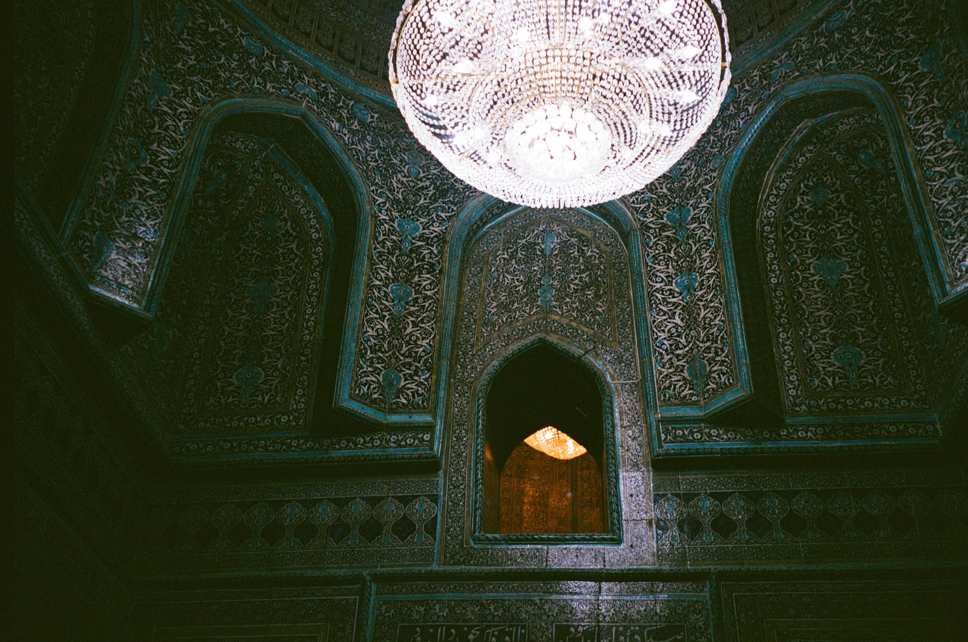 A dim, tiled interior lit by a round skylight